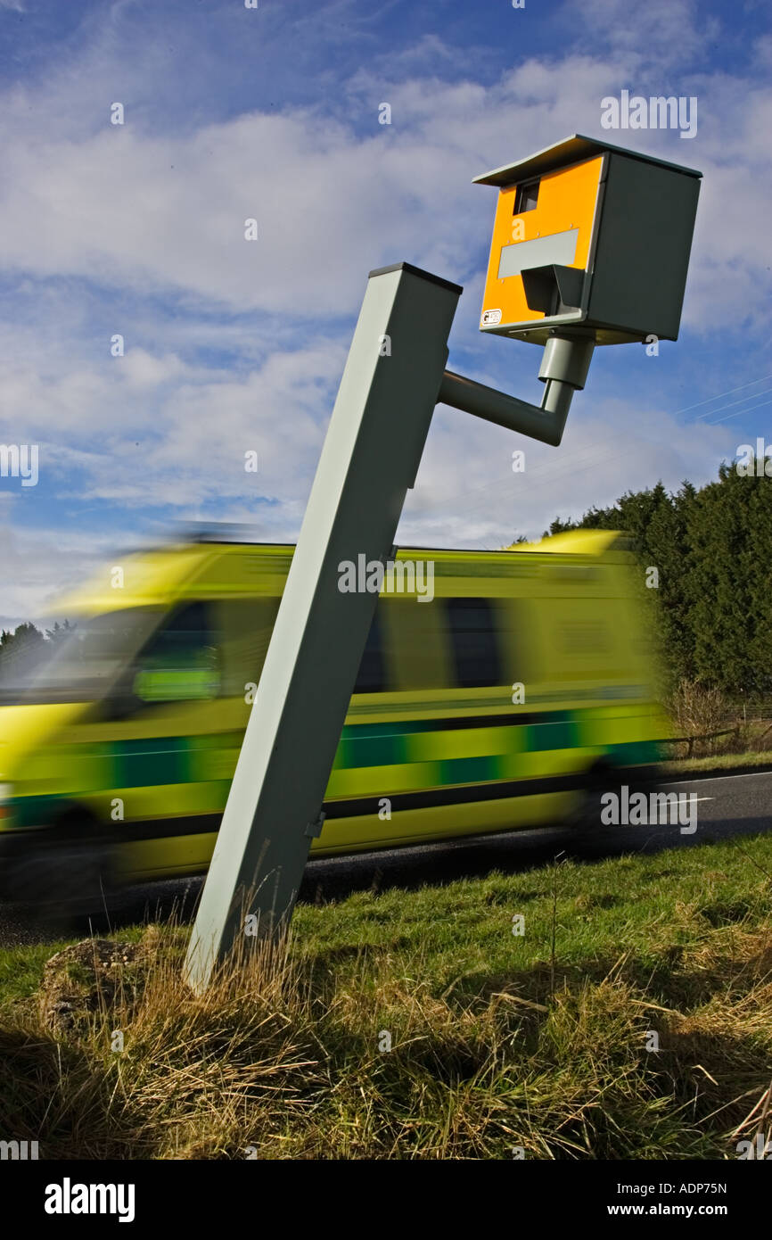 Ambulance passes vandalised Gatso speed camera on A40 Oxfordshire England United Kingdom Stock Photo