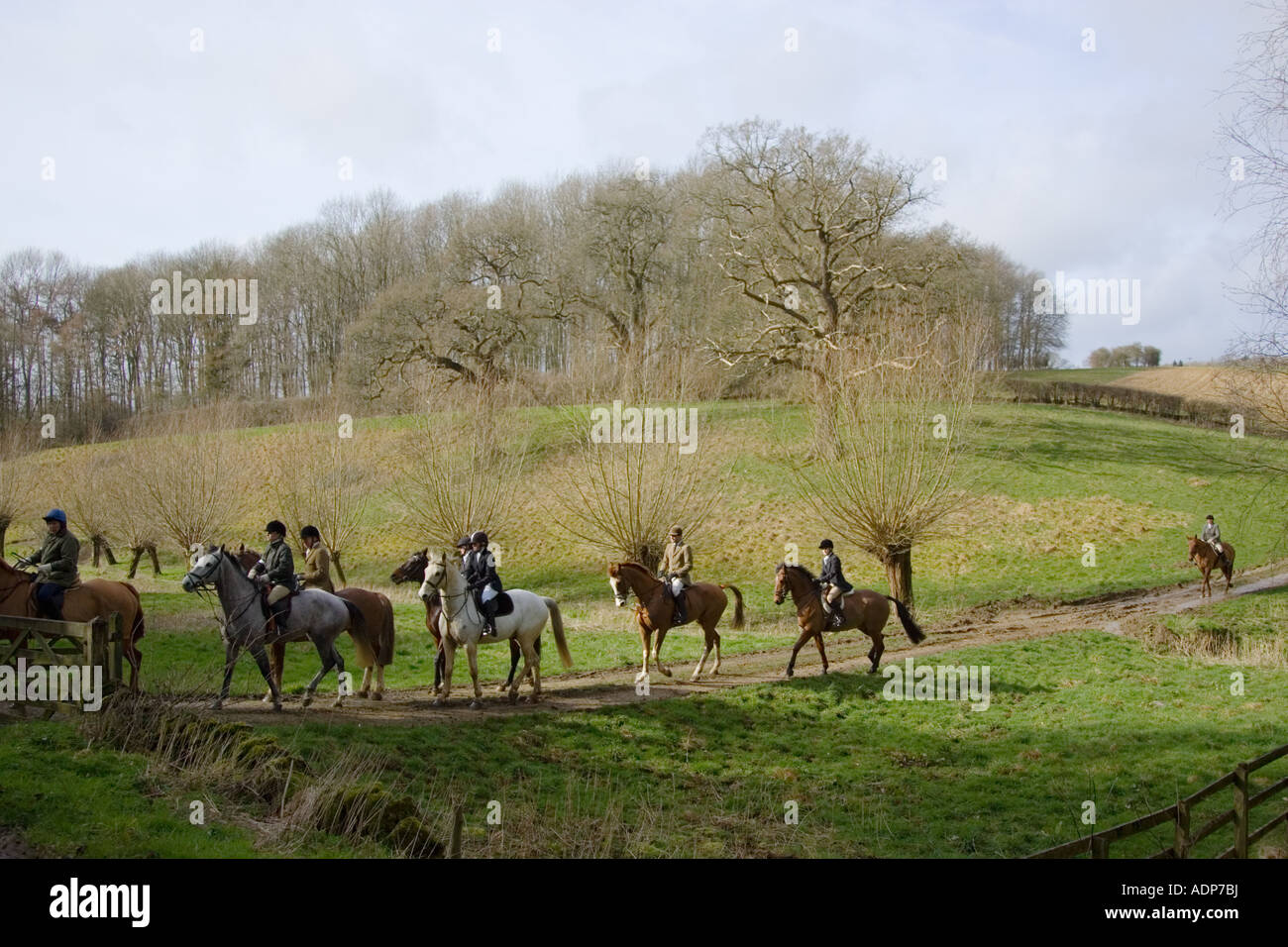 Members of Heythrop Hunt ride across Oxfordshire countryside United Kingdom Stock Photo