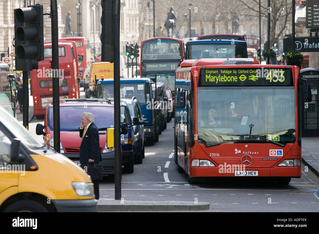 Heavy traffic at a standstill at traffic lights in Trafalgar Square London city centre England United Kingdom Stock Photo