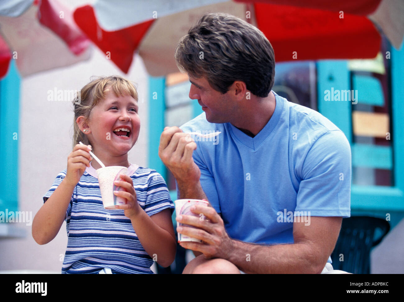 Father and daughter eating Italian ices Stock Photo