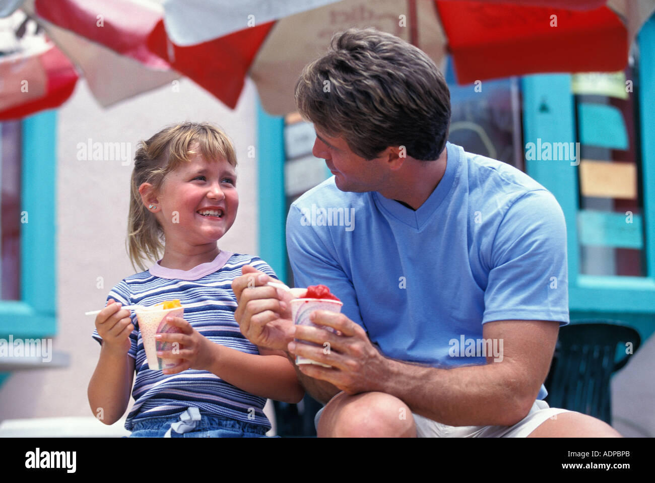 Father and daughter enjoying Italian Ices Stock Photo