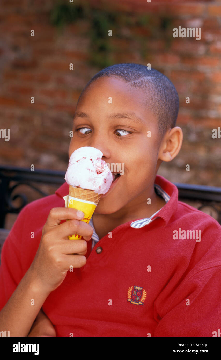 African American boy with brain freeze from eating ice cream cone Stock