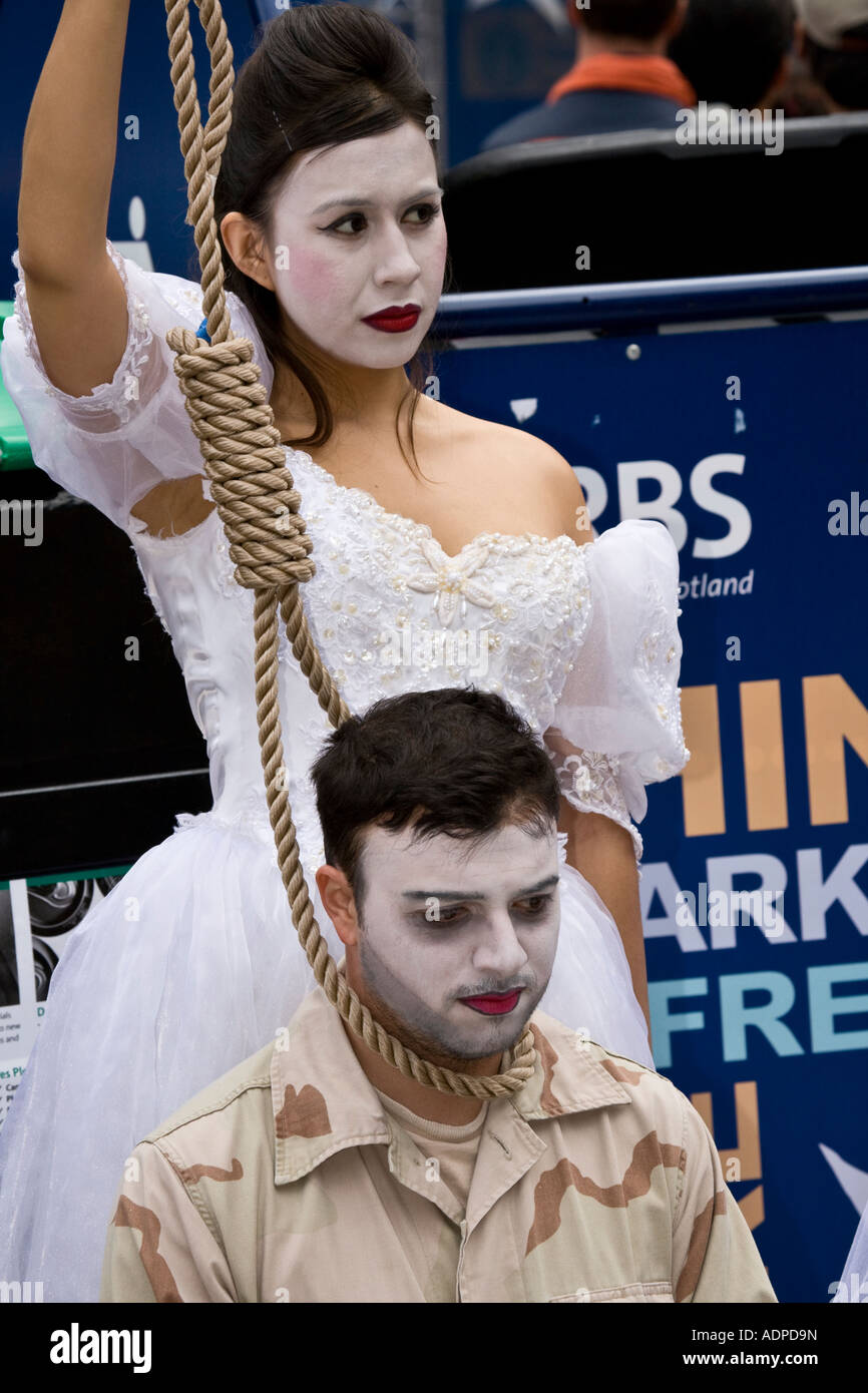 Performers from the anti-war play melancholia stage a mock execution at the Edinburgh festival fringe Royal Mile, Scotland. Stock Photo