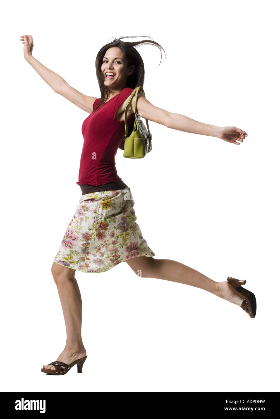 Woman with purse running and smiling Stock Photo