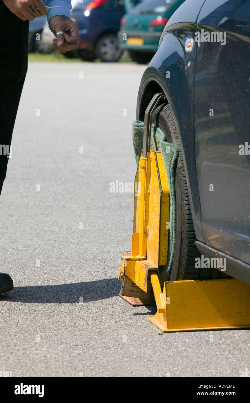 man clamping a car at Newquay airport, Cornwall, UK Stock Photo Alamy