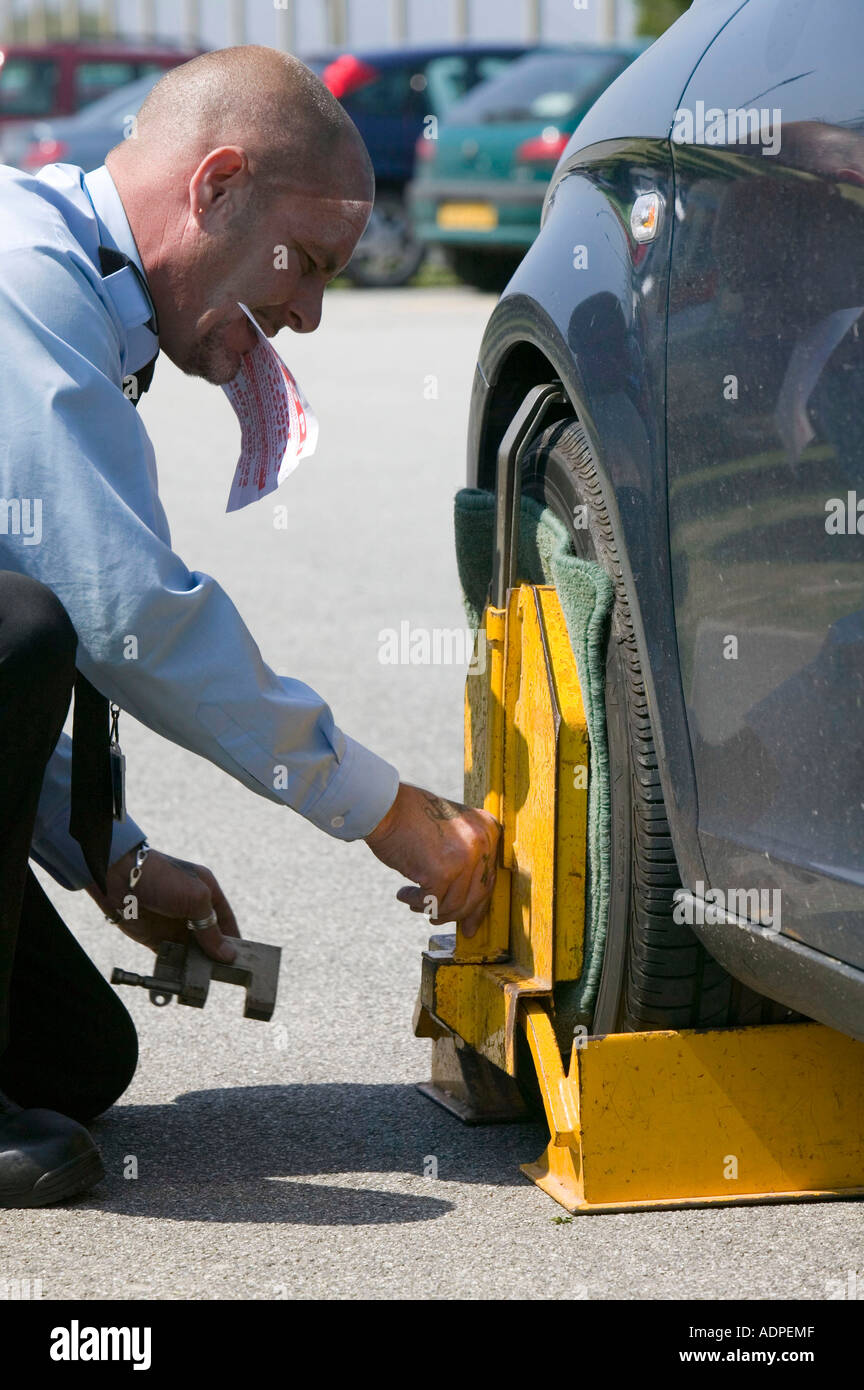man clamping a car at Newquay airport, Cornwall, UK Stock Photo Alamy
