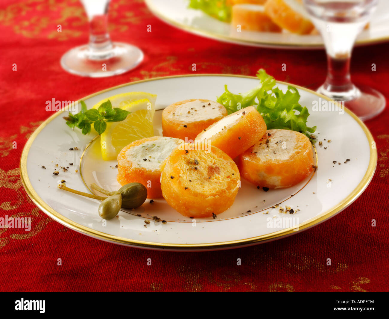Smoked salmon rolls filled with cream cheese and cream cheese and peppers in a party buffet setting Stock Photo