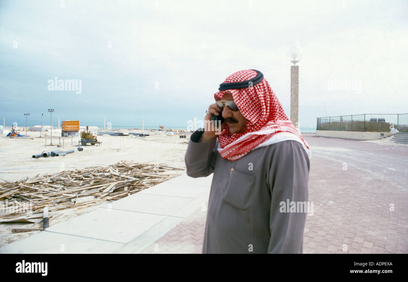 Kuwait City Kuwait Kuwaiti & Mobile Phone On Building Site Stock Photo