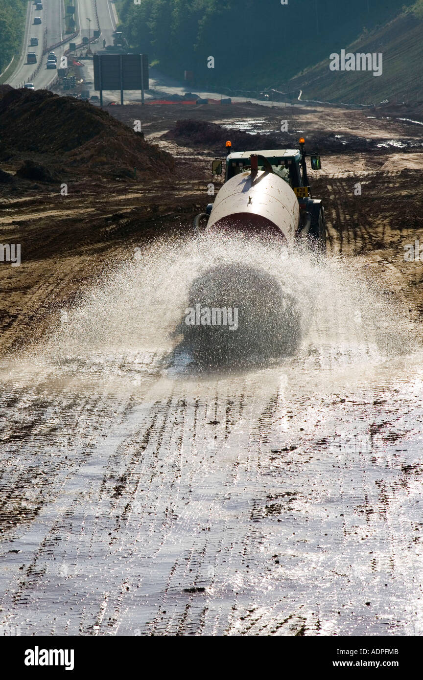 damping down dust on a roadbuilding project, on the A30, Cornwall, UK Stock Photo
