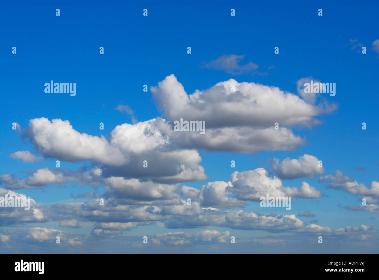 Banks of white fluffy clouds against a deep blue sky Stock Photo - Alamy