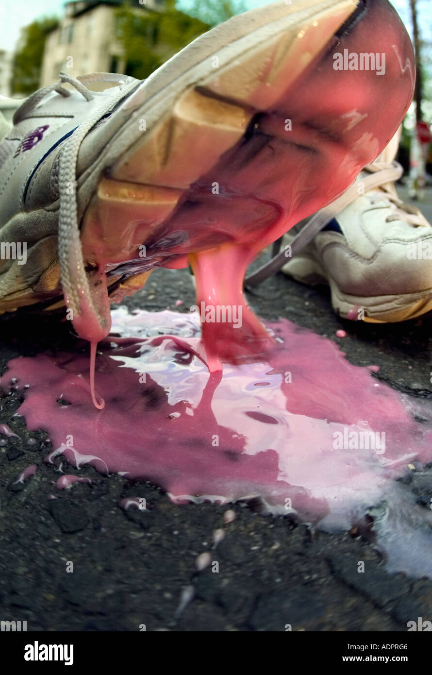 Sneaker stepping in pink sludge Stock Photo