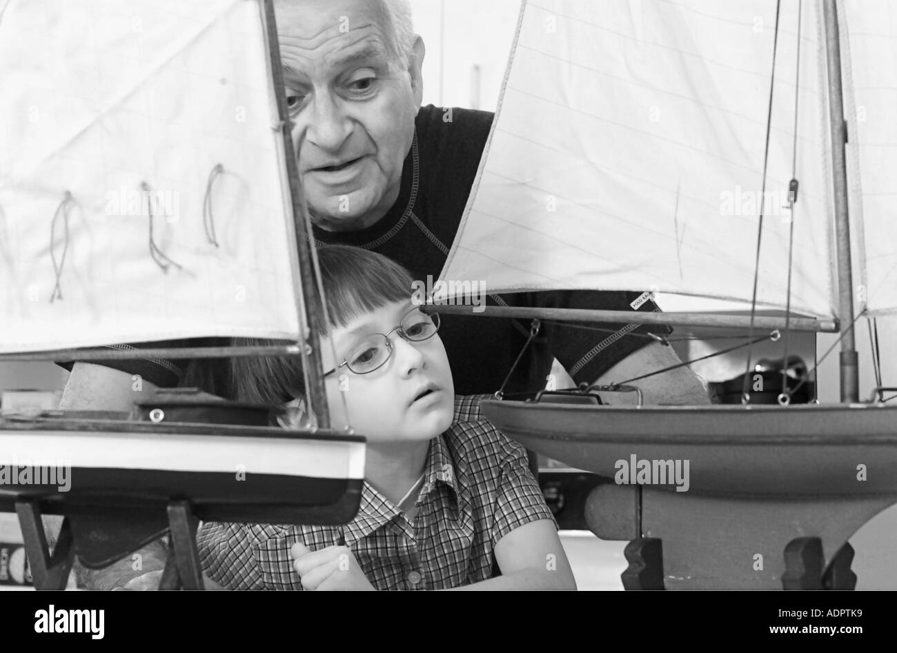 Grandfather Showing Grandson his Boat Models Stock Photo