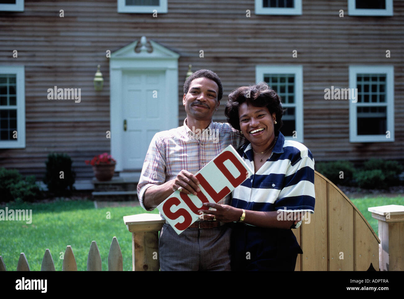African American couple pose in front of their new home Stock Photo - Alamy