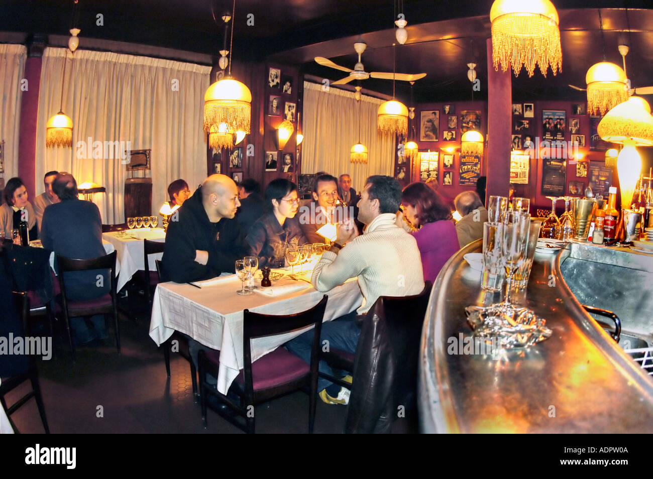 PARIS France, Adults Sharing Meals, Drinks at Table Talking inside Typical French Bistro Restaurant, 'Chez Arthur' interior, women dining, Lights Stock Photo