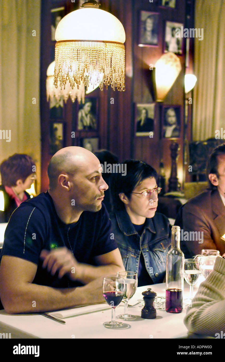 PARIS France, Group Adults Sharing meals in French Bistro Restaurant 'Chez Arthur' Conversation around table After Dinner, lights bistrot interior Stock Photo
