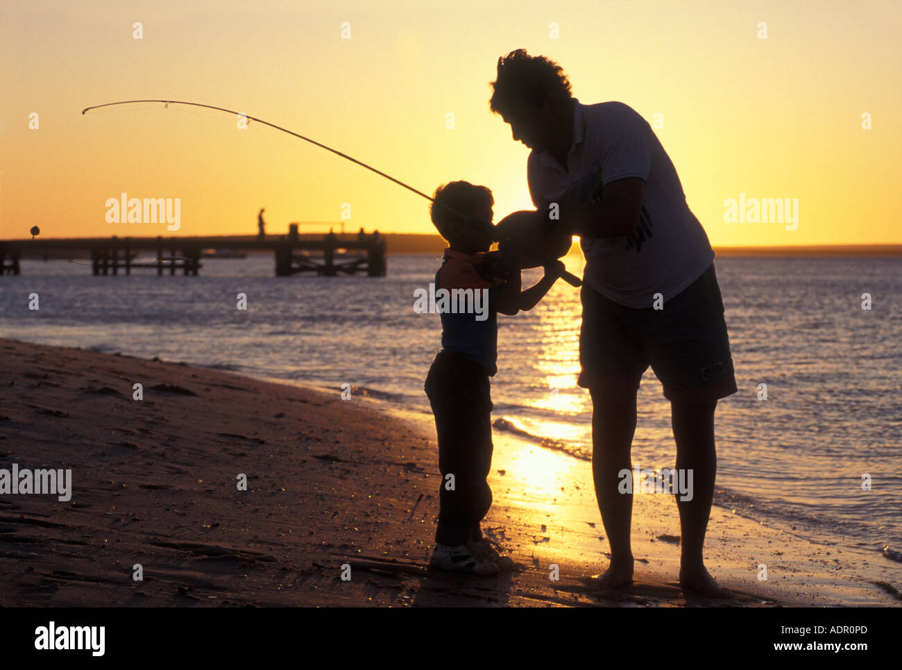 Silhouette father son fishing sunset hi-res stock photography and ...
