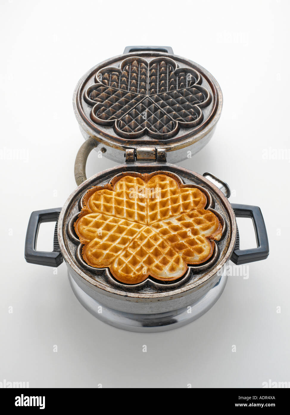 Waffle in a waffle iron Stock Photo