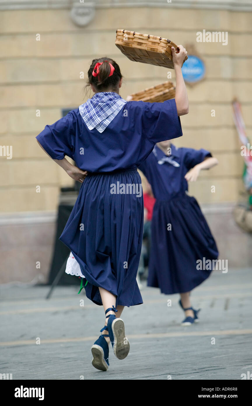 Young Basque girls dressed in blue perform a traditional Basque folk dance carrying baskets Plaza Arriaga Bilbao Stock Photo