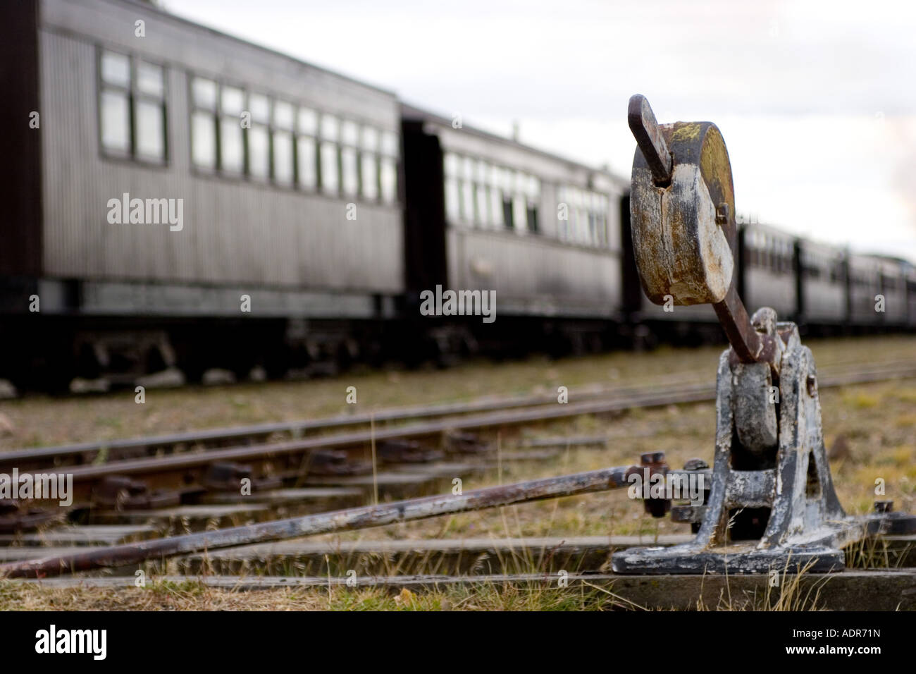 Detail of train rail changer with train in the background. Stock Photo