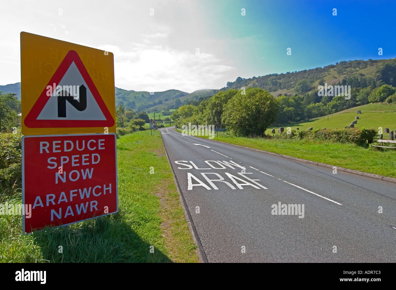 Bilingual Welsh road sign, (reduce speed now) Wales, UK Stock Photo Alamy