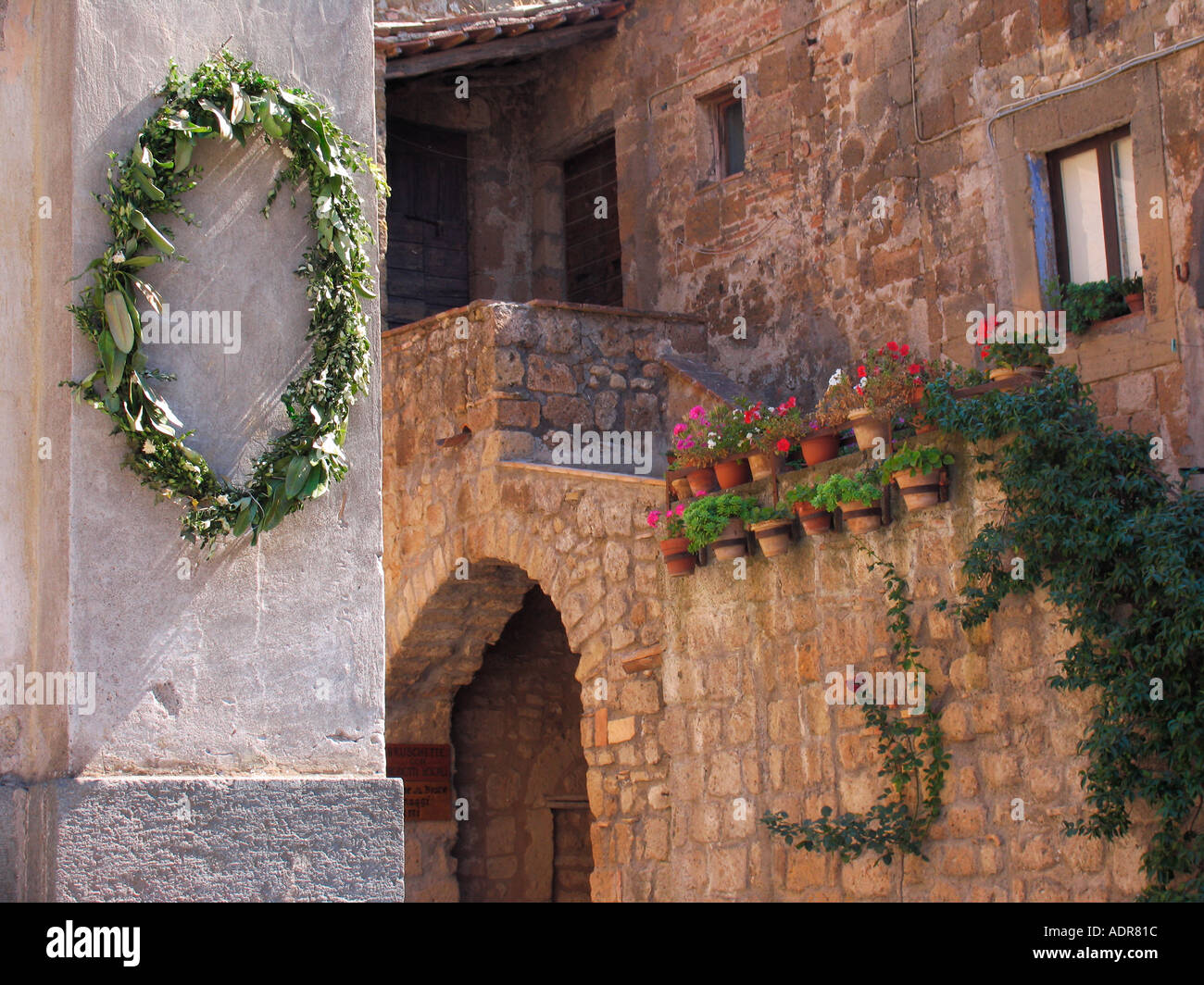 Wedding wreath hangs on corner of church in Civita de Bagnoregio Stock Photo