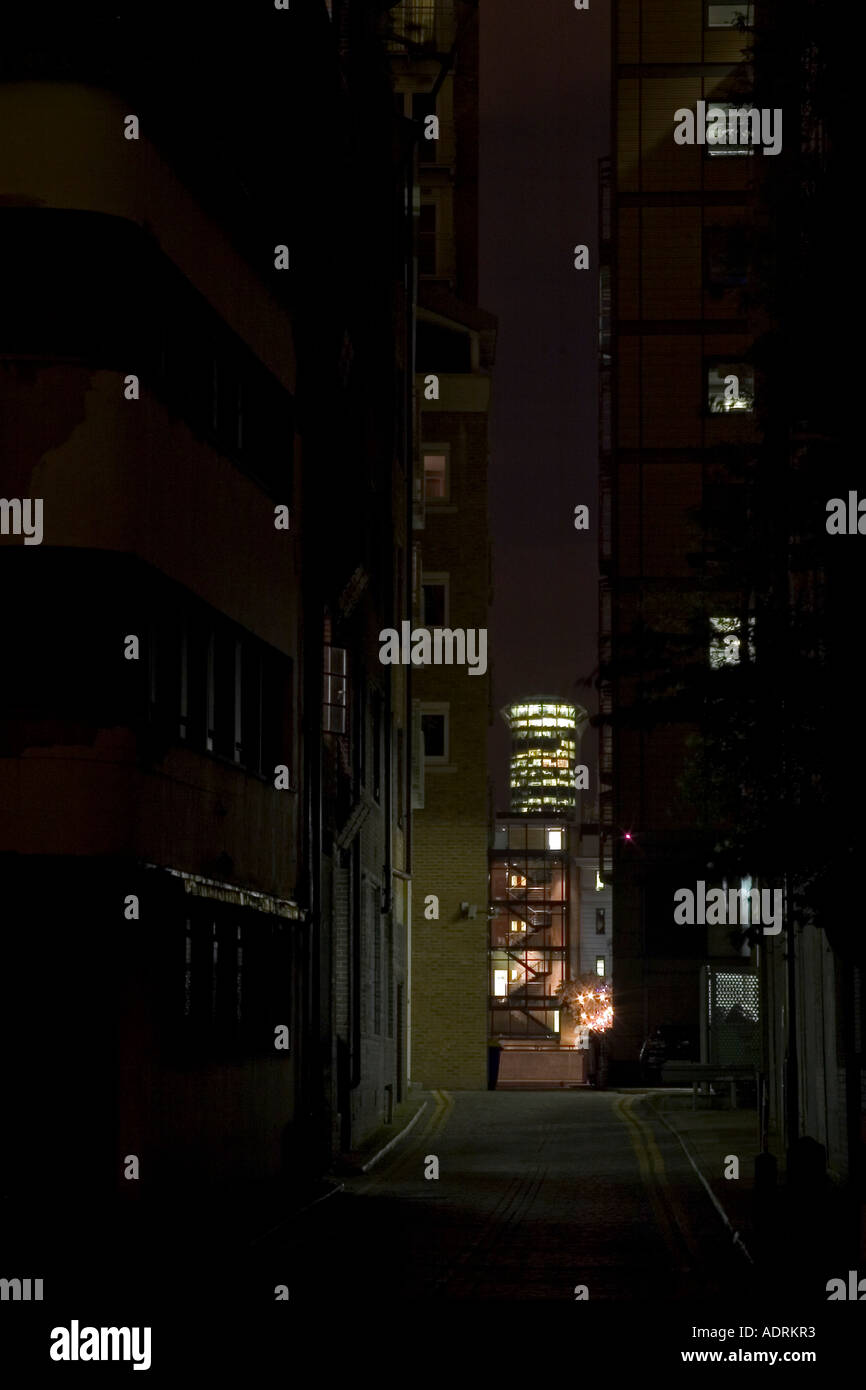 Dark sinister urban alley leading to bright city lights. Bear Gardens, Southwark, London, England Stock Photo