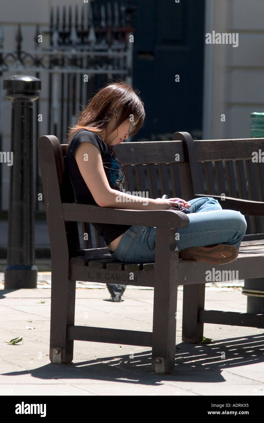 Girl sitting on bench hi-res stock photography and images - Alamy