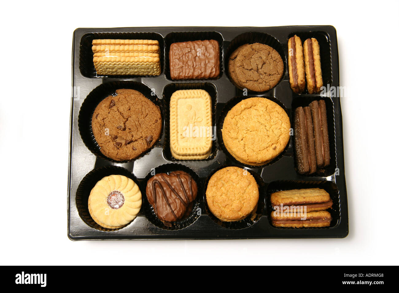 Selection box of biscuits isolated on a white studio background Stock