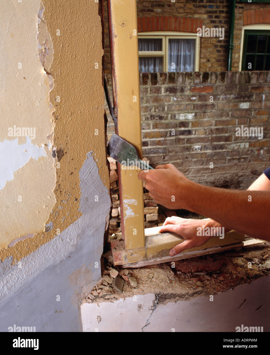 Close Up Of Hands Removing Old Door Wooden Frame Stock Photo