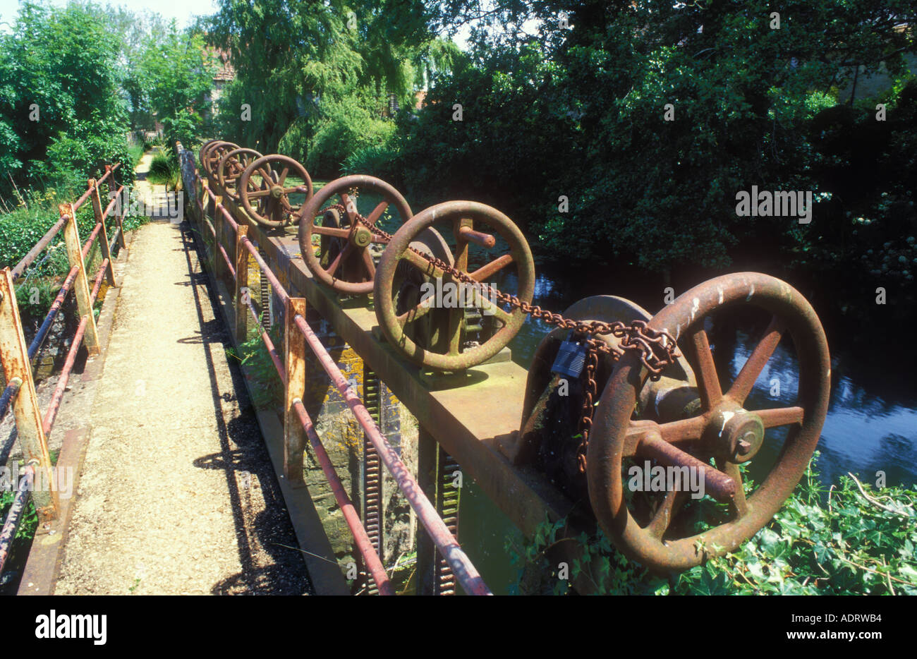 Silt-laden water rushing over a weir on the River Stour Blandford Dorset  England UK Stock Photo - Alamy