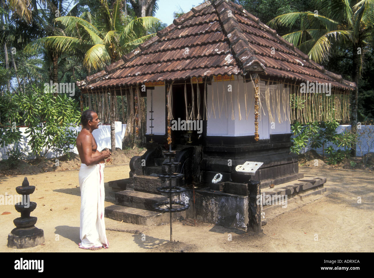 Brahmin man worships at his family temple in Kerala, SW India Stock Photo