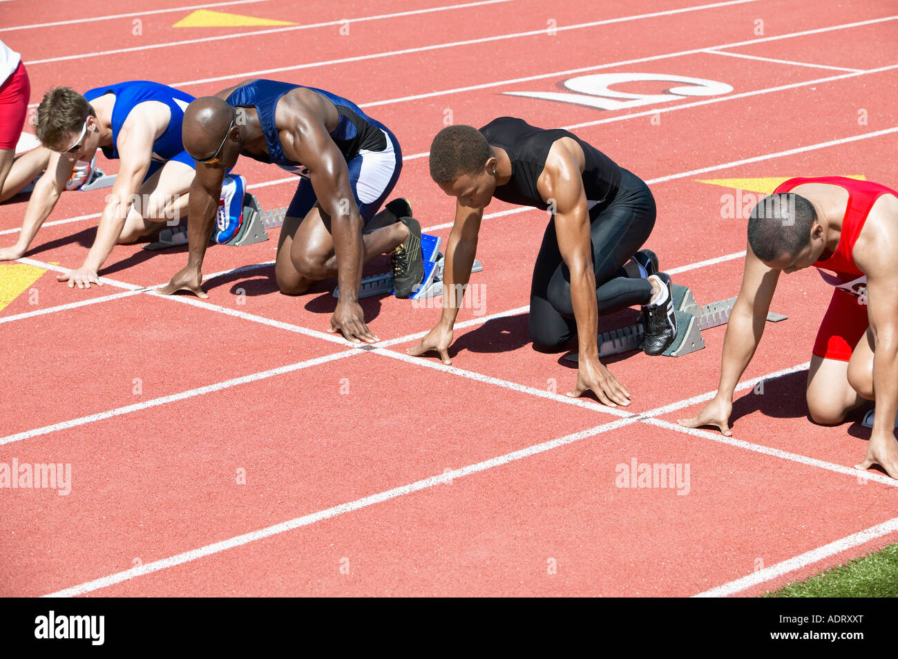 Runners Waiting in Starting Blocks Stock Photo Alamy