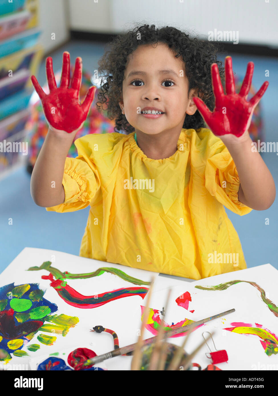 Girl finger painting in art class, elevated view Stock Photo Alamy