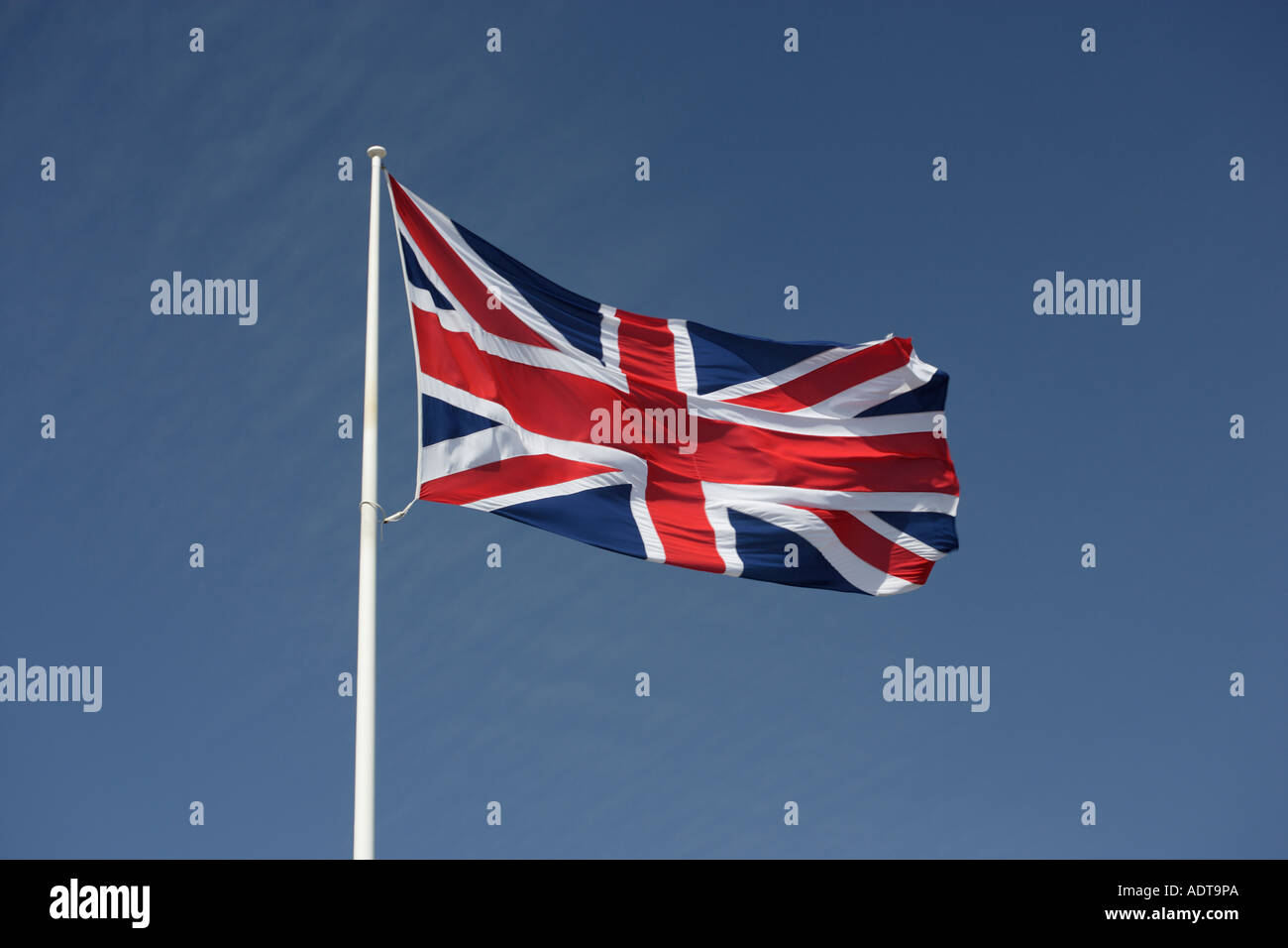 British Union flag fluttering on flagpole Union Jack Stock Photo