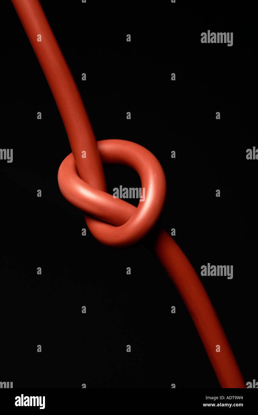 Knot in electrical cable on black background, closeup, problem