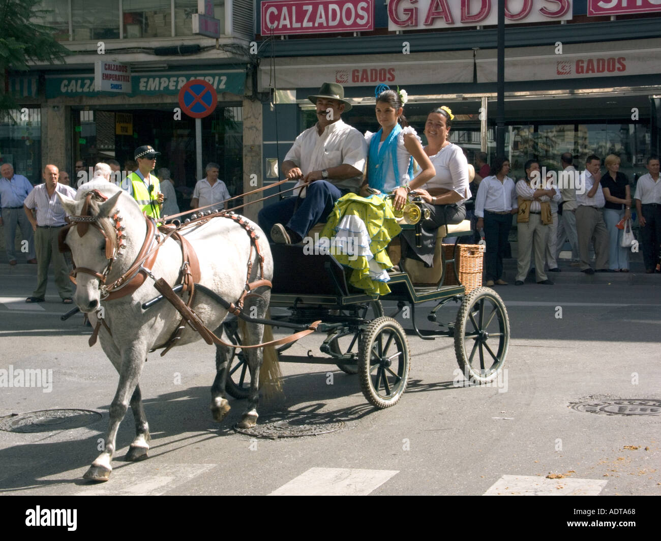 Spanish People riding in an open horse drawn carriage at the Fuengirola