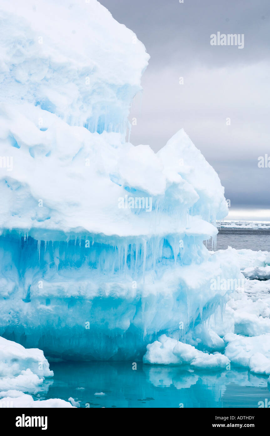 Iceberg floating in moving pack ice. Icicles form as the ice melts in