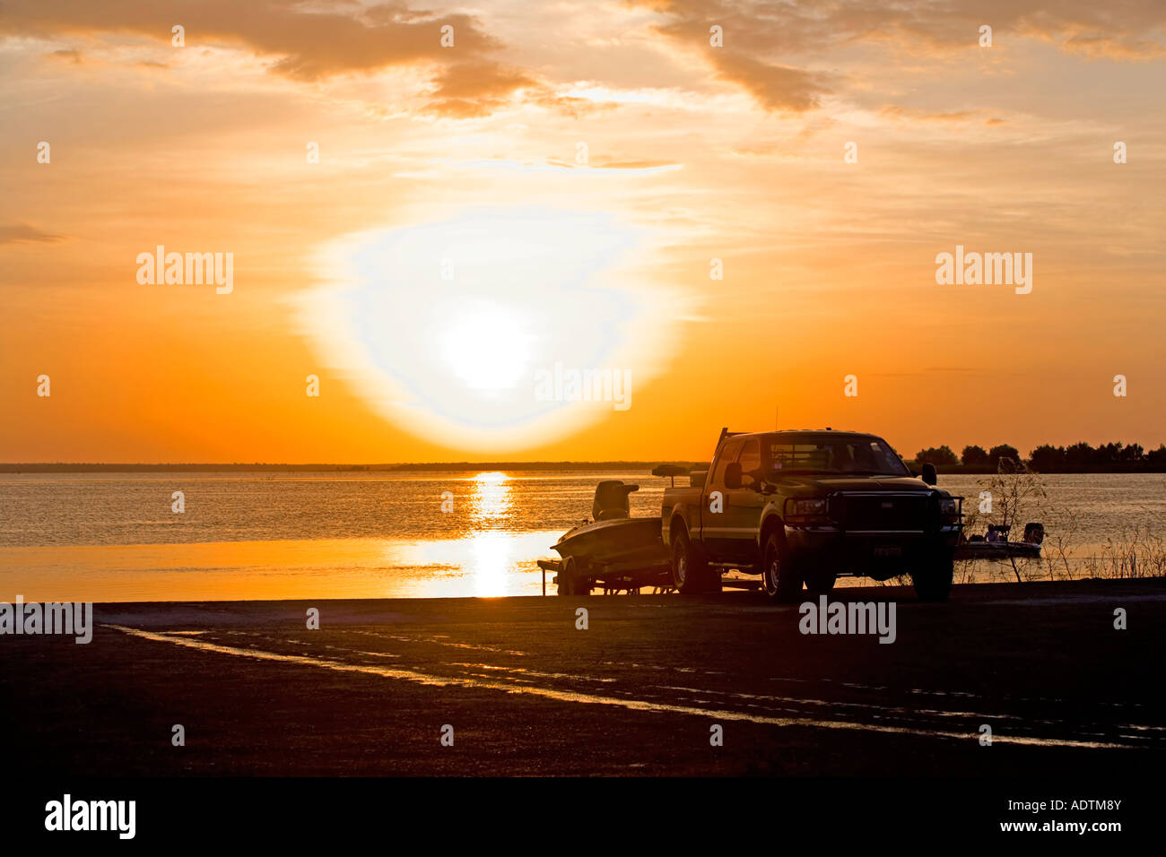 Ford Truck and boat sunset dock Texas lake fisherman Stock Photo