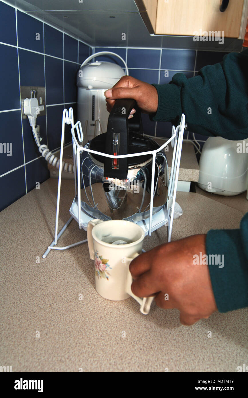 Disability aid to help pour hot water from a kettle Stock Photo