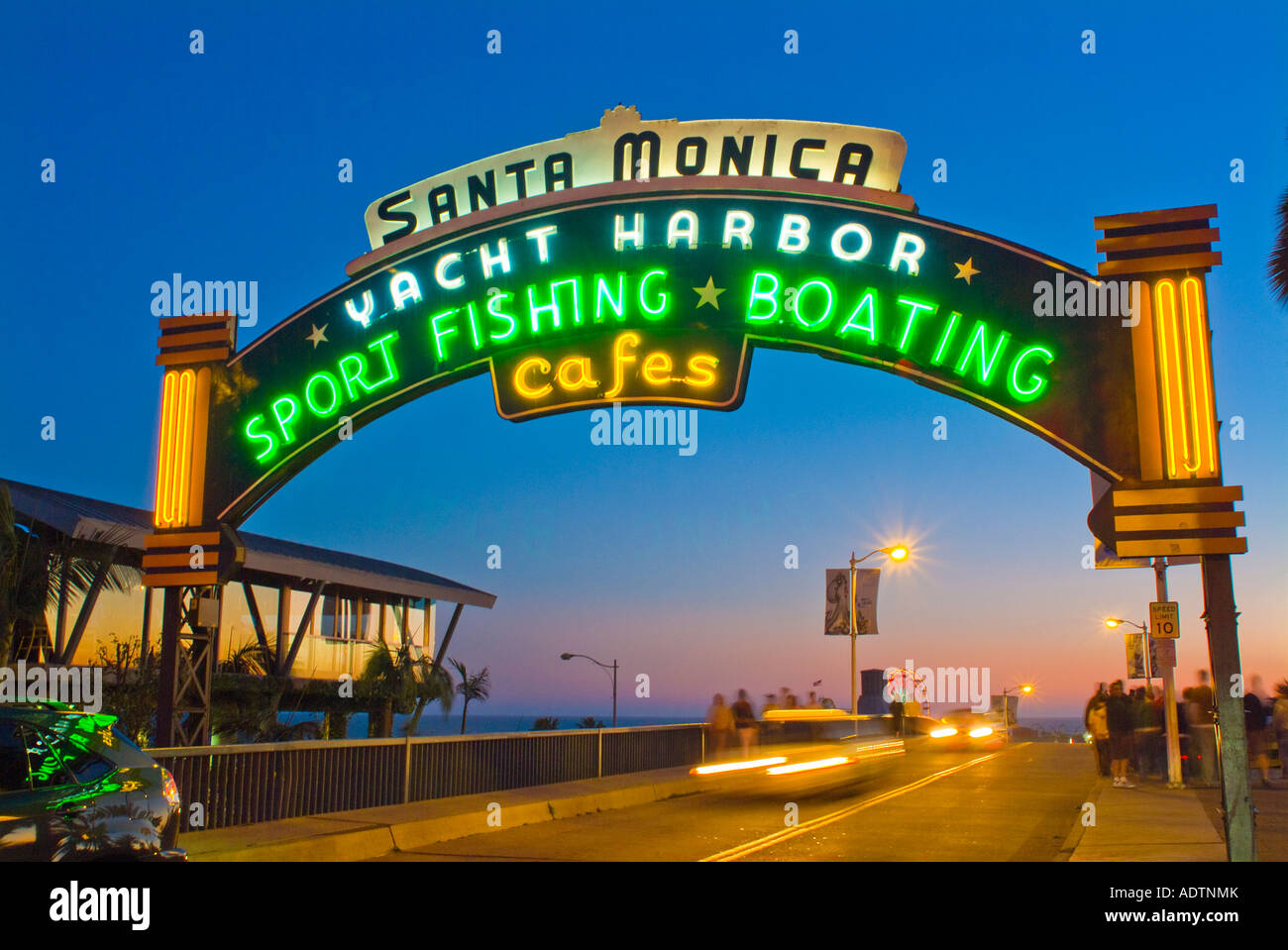 Night photography of Santa Monica pier sign with cars moving under the sign Stock Photo