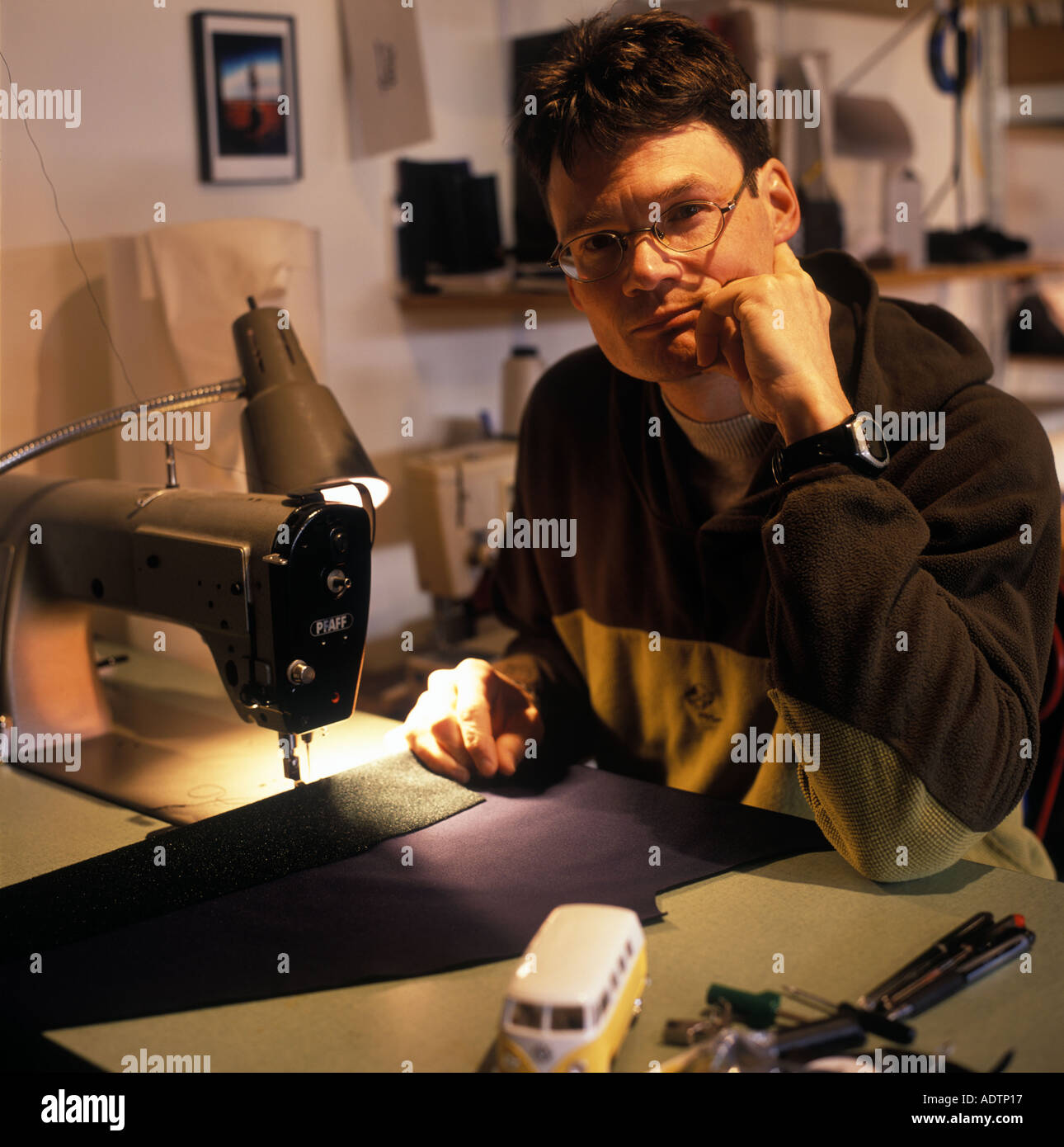 Portrait of male clothing designer at his sewing machine Stock Photo