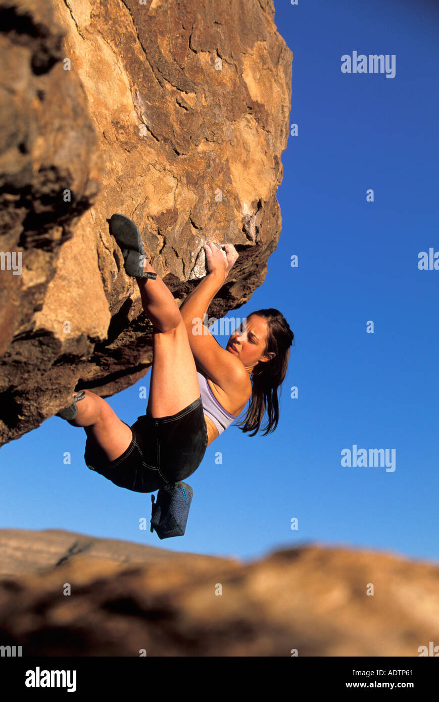 Female rock climbing on a steep boulder Stock Photo Alamy