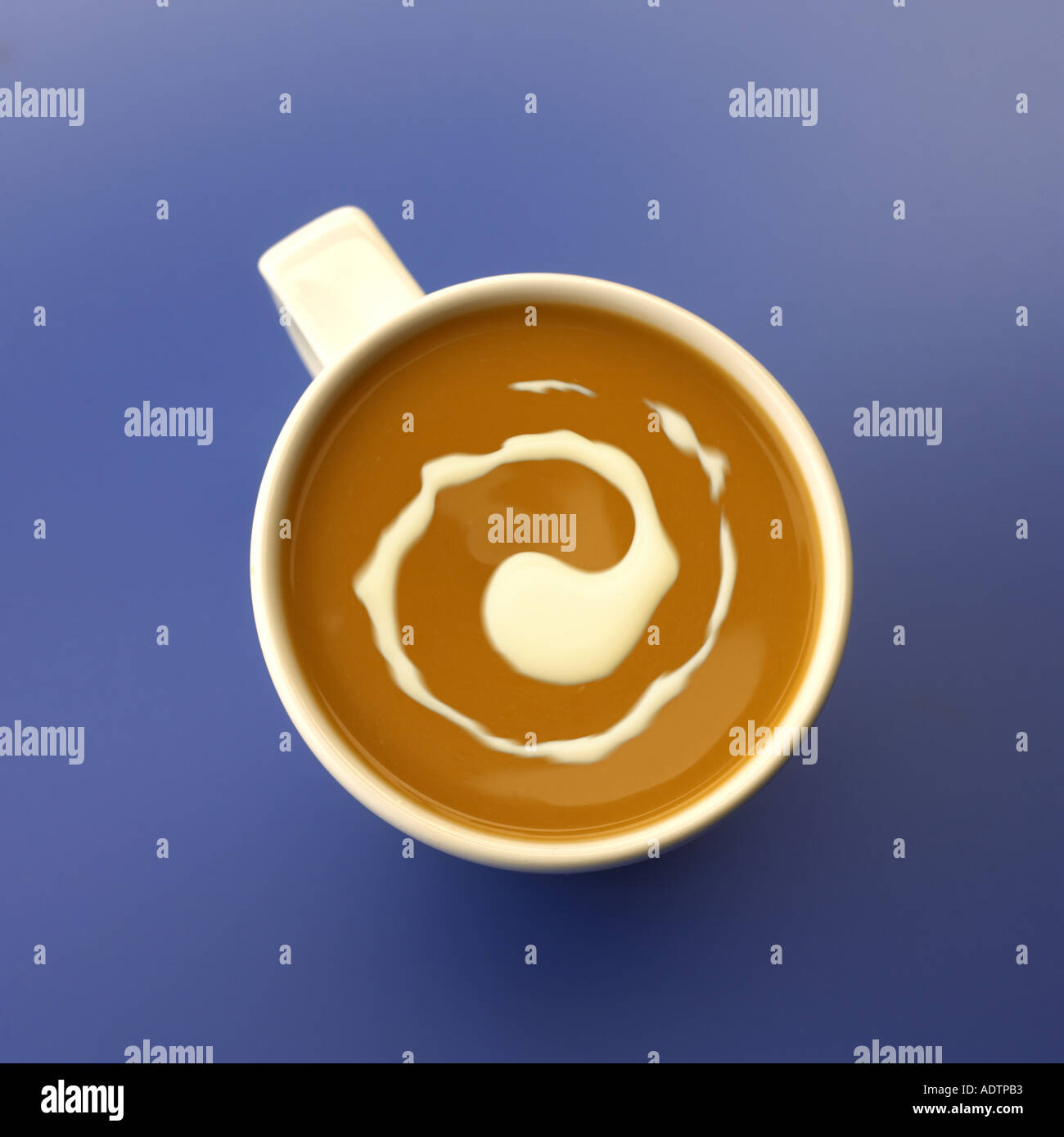 Mug of coffe with cream swirl Stock Photo