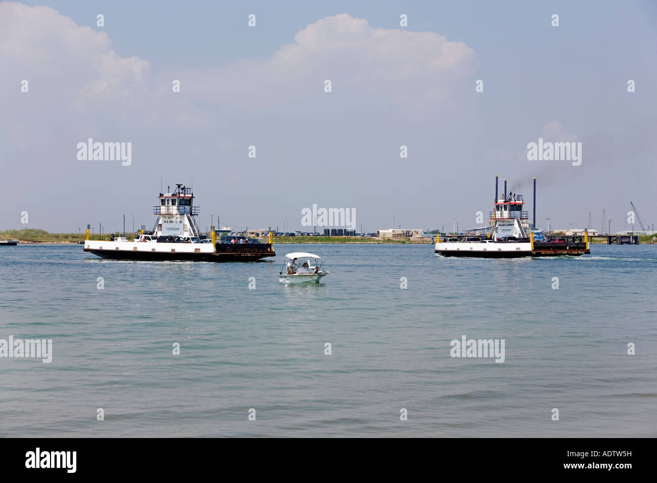 Ferries and a fishing boat Port Aransas TX. Car crossing over bay