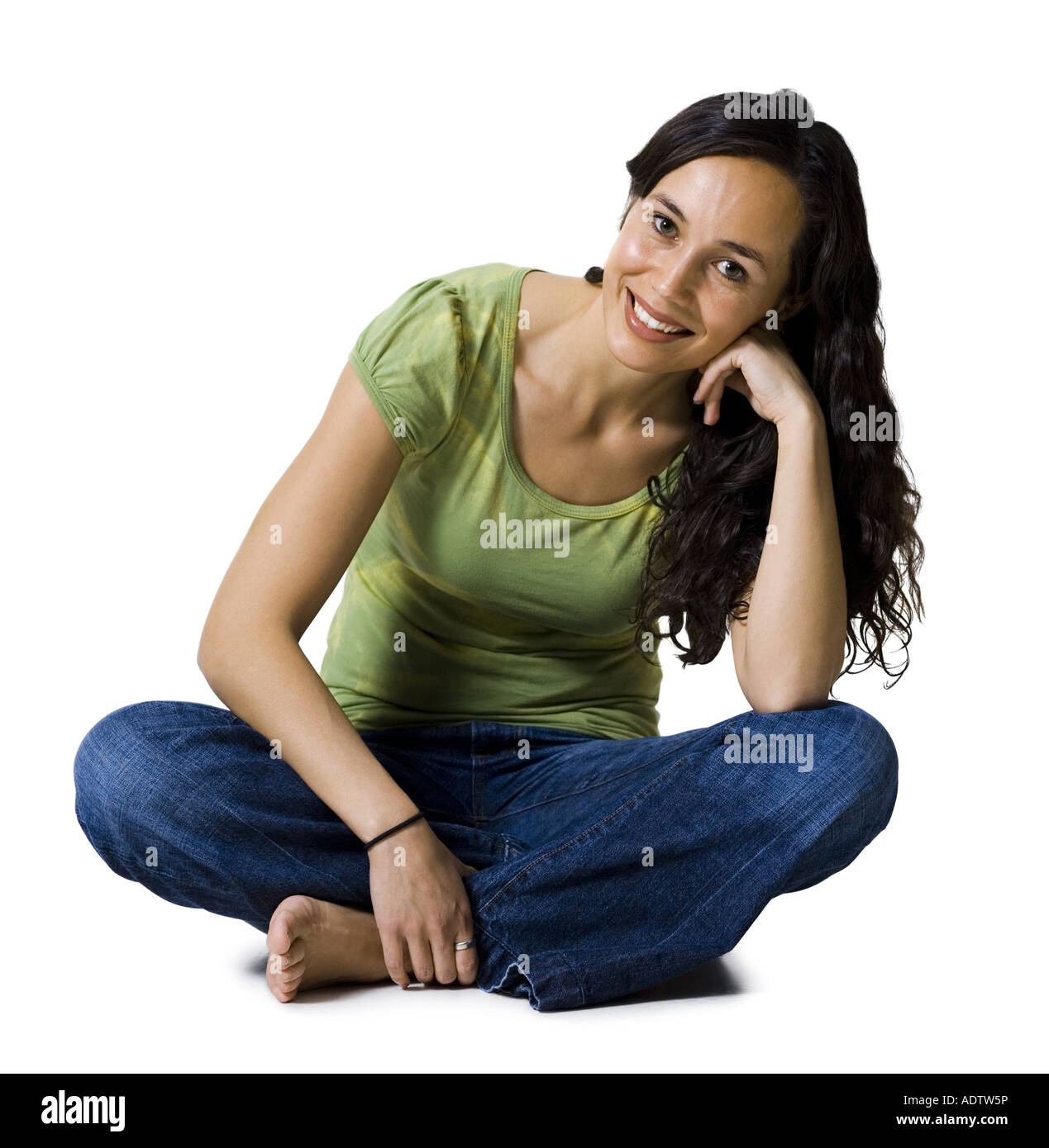 Woman sitting cross legged smiling Stock Photo