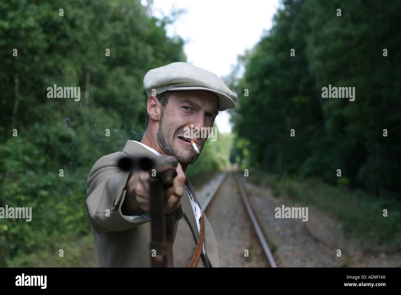 man with gun on the railroad Stock Photo Alamy