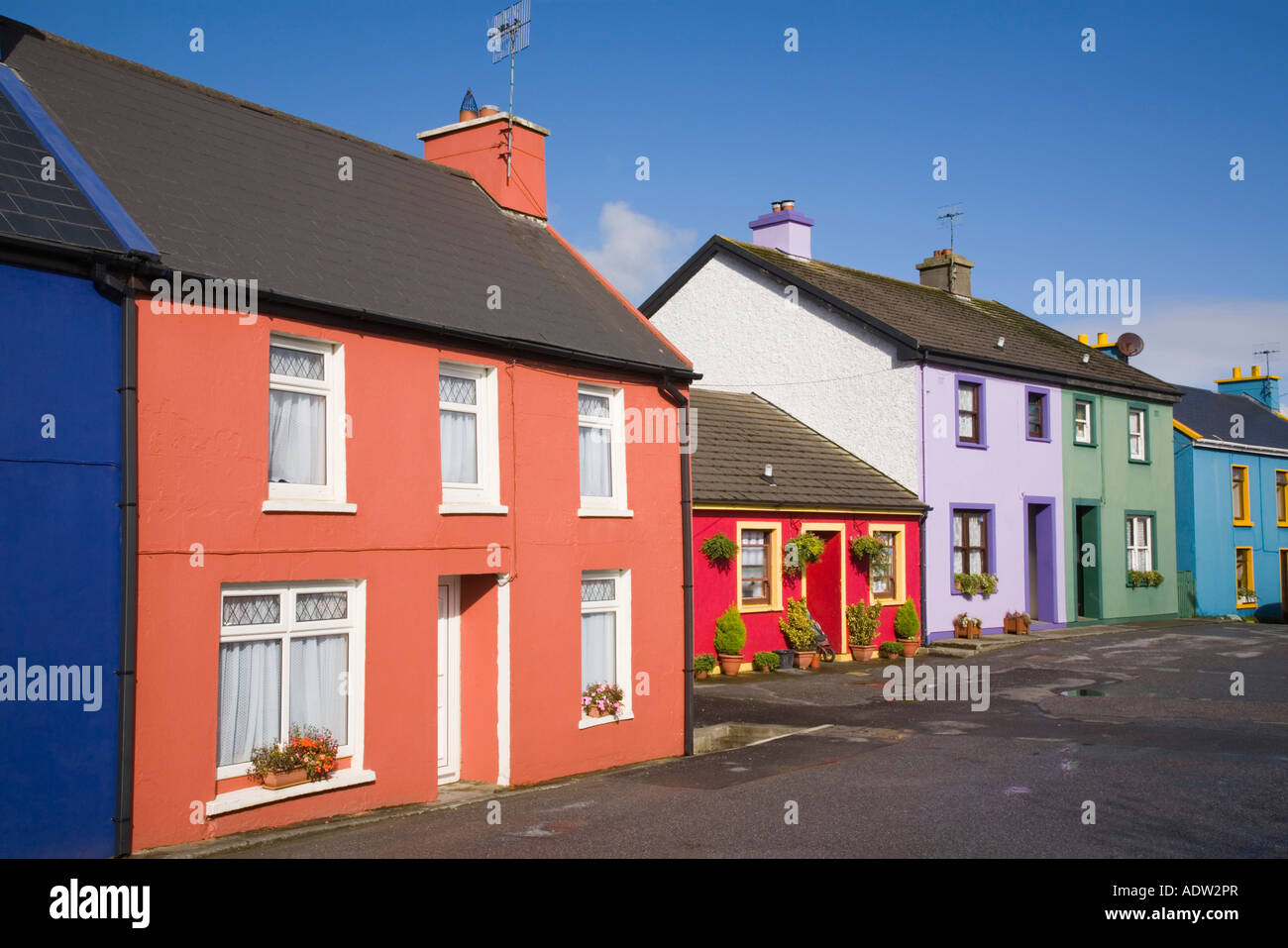 Row of colourful houses in main street in village on Ring of Beara route on Beara peninsula Eyeries County Cork Ireland Eire Stock Photo