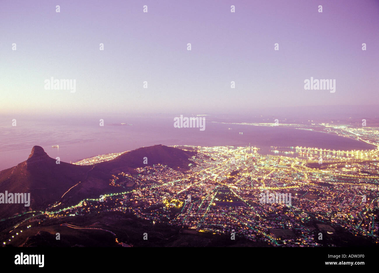 Table Bay and Robben Island at night, left Lions Head (669m) and Signal Hill (350m) from Table Mountain (1087), Capetown (Kaapst Stock Photo