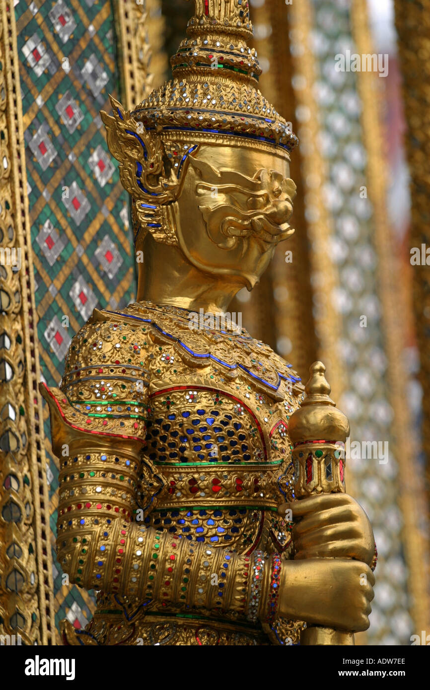 Golden statue at the Grand Palace in Bangkok guards the entrance to a ...