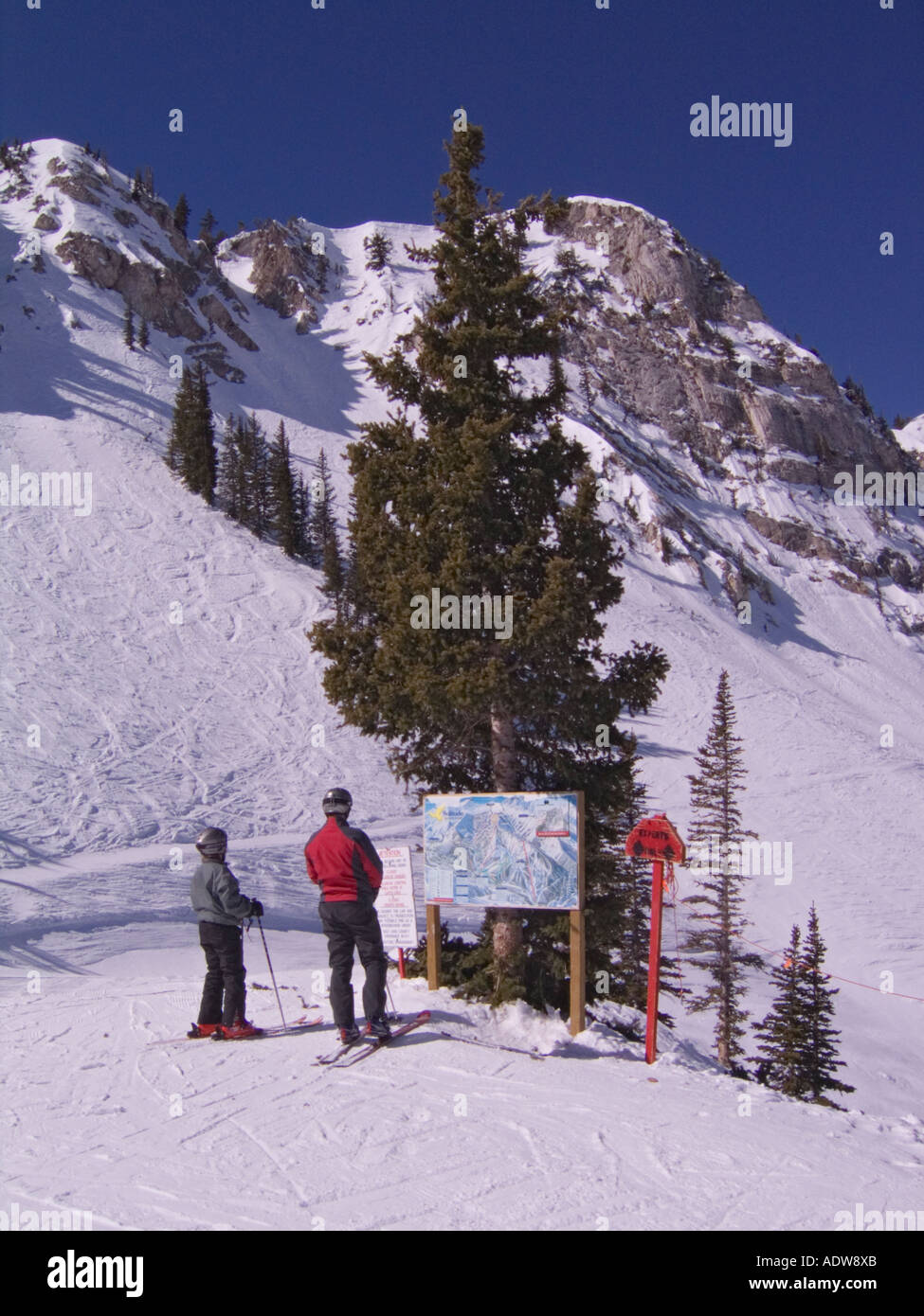 Utah Solitude ski and snowboard resort skiers reading trail sign Stock Photo